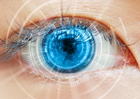 Close up of blue eye with laser effects over it