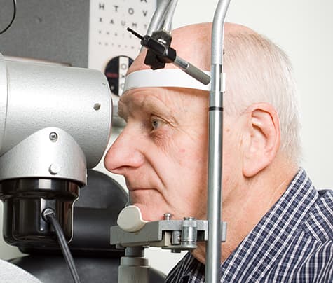 Older man gettting eyes examined